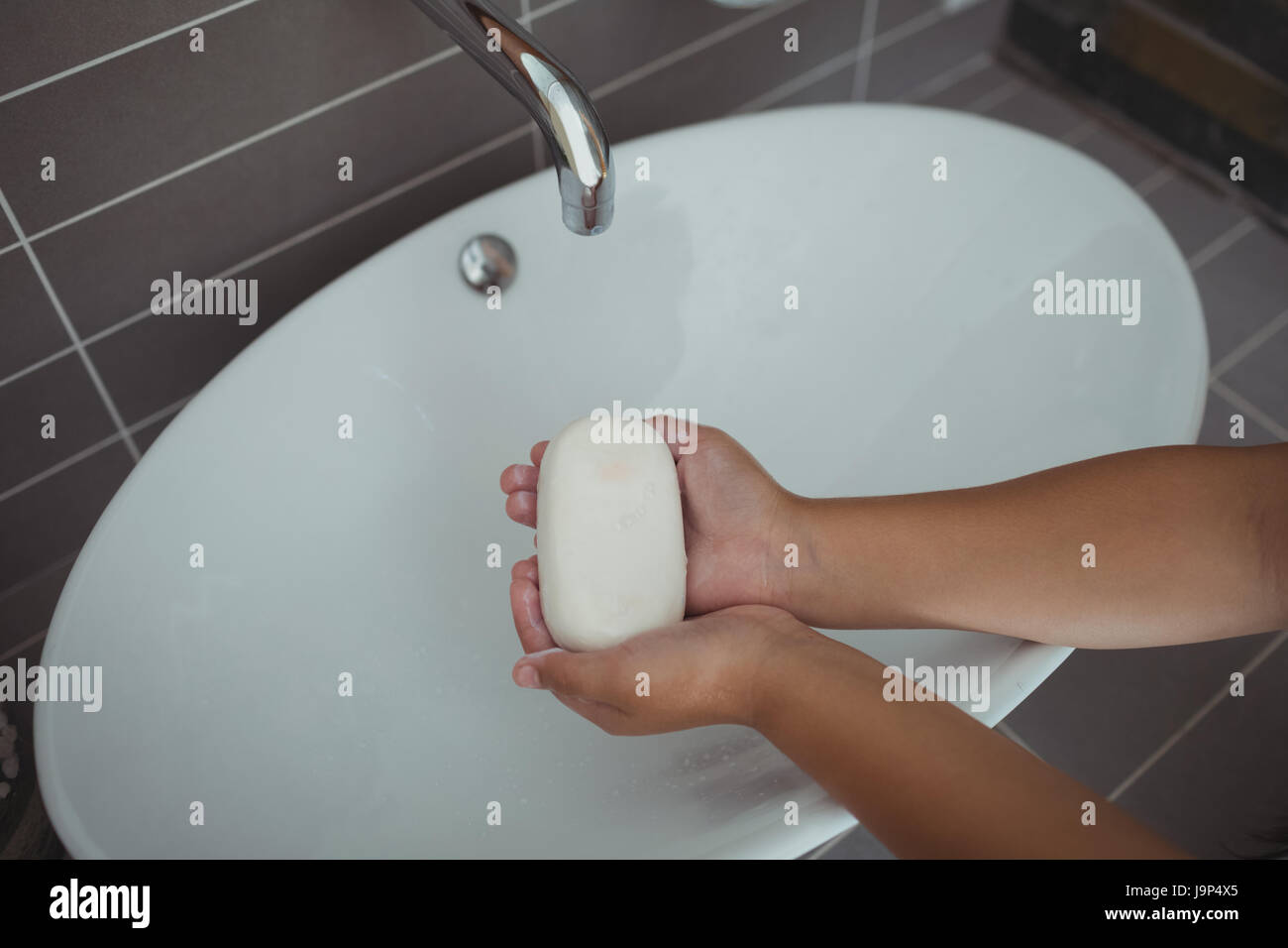 Close-up of girl washing hands in bathroom sink at home Stock Photo - Alamy