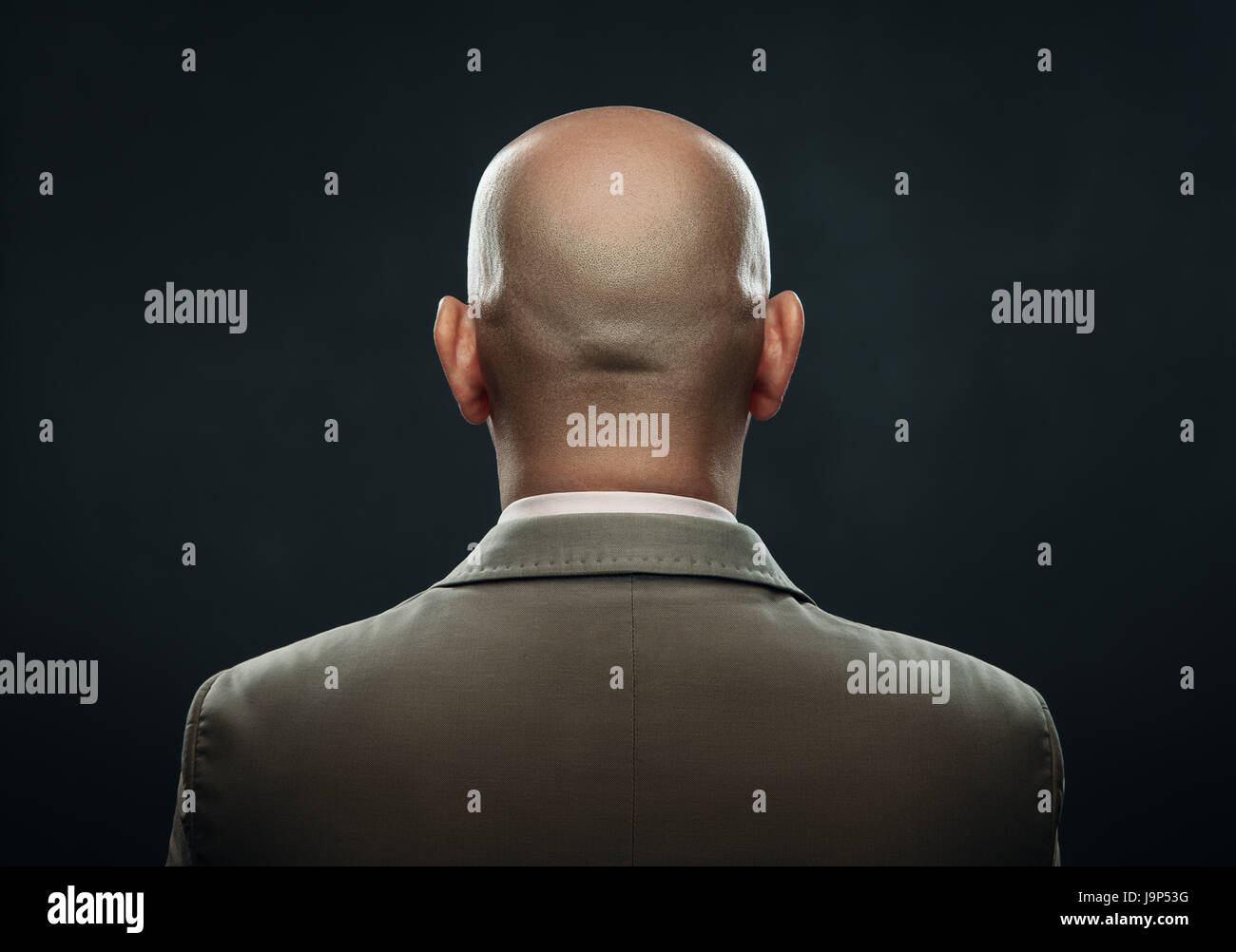 The back of a bald man in suit Stock Photo