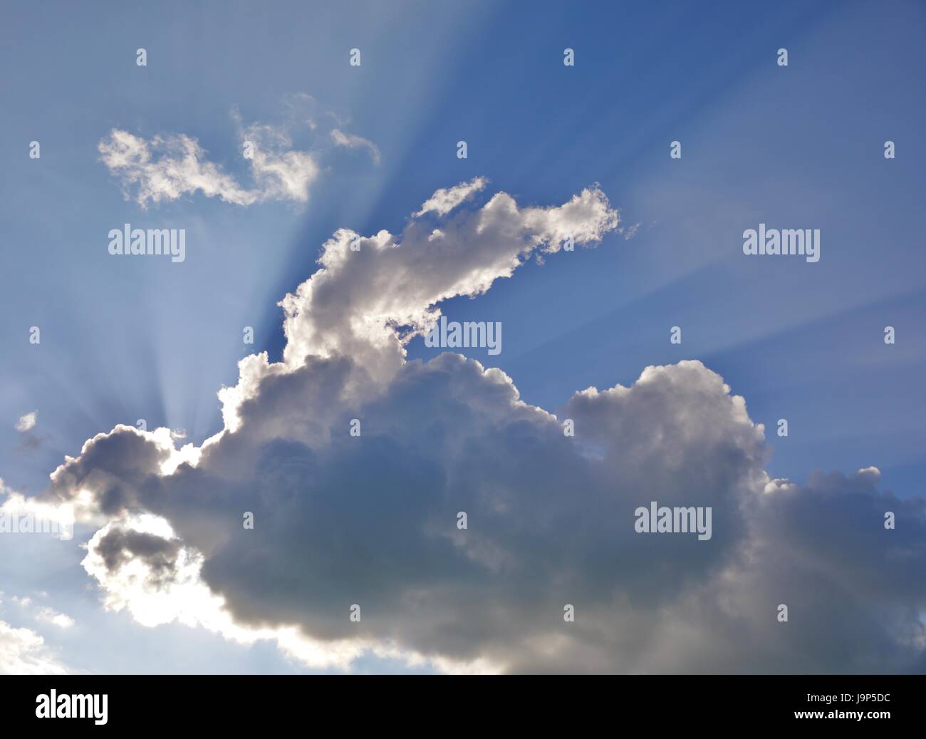 Rays of light shining through clouds Stock Photo