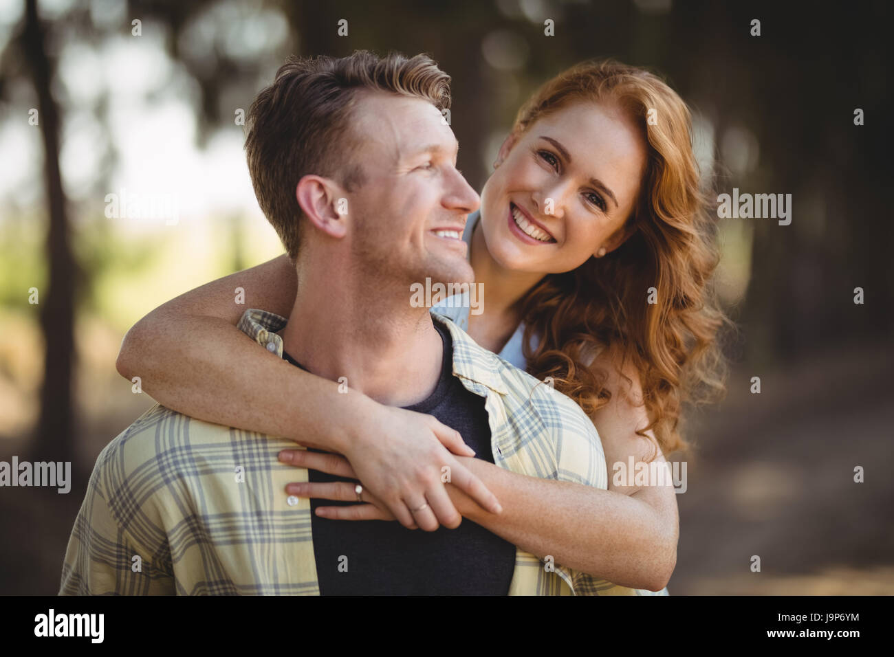 Portrait of smiling woman embracing man at olive farm Stock Photo - Alamy