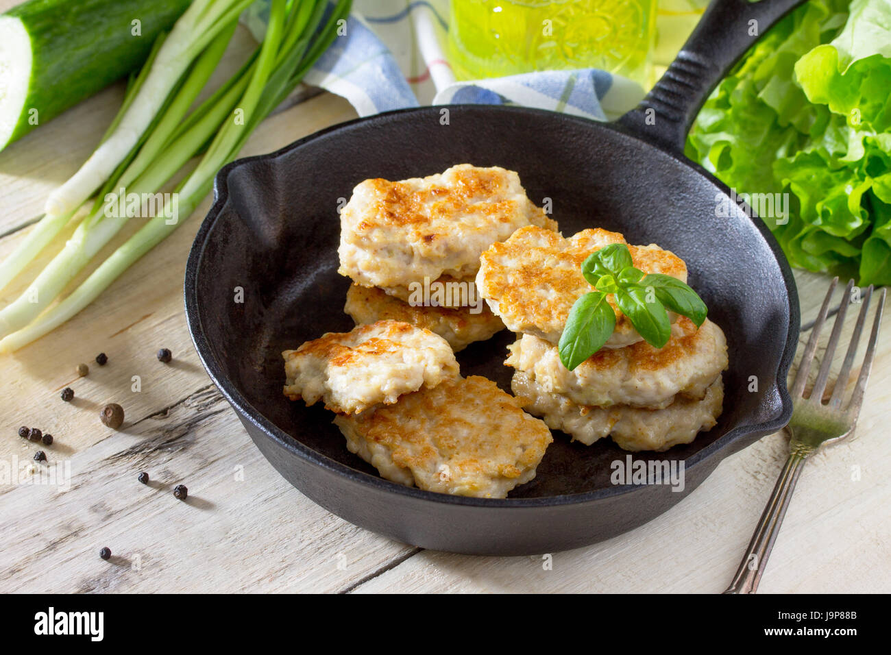 Meat cutlet from minced meat, served in a castiron frying pan with green beans kitchen table in