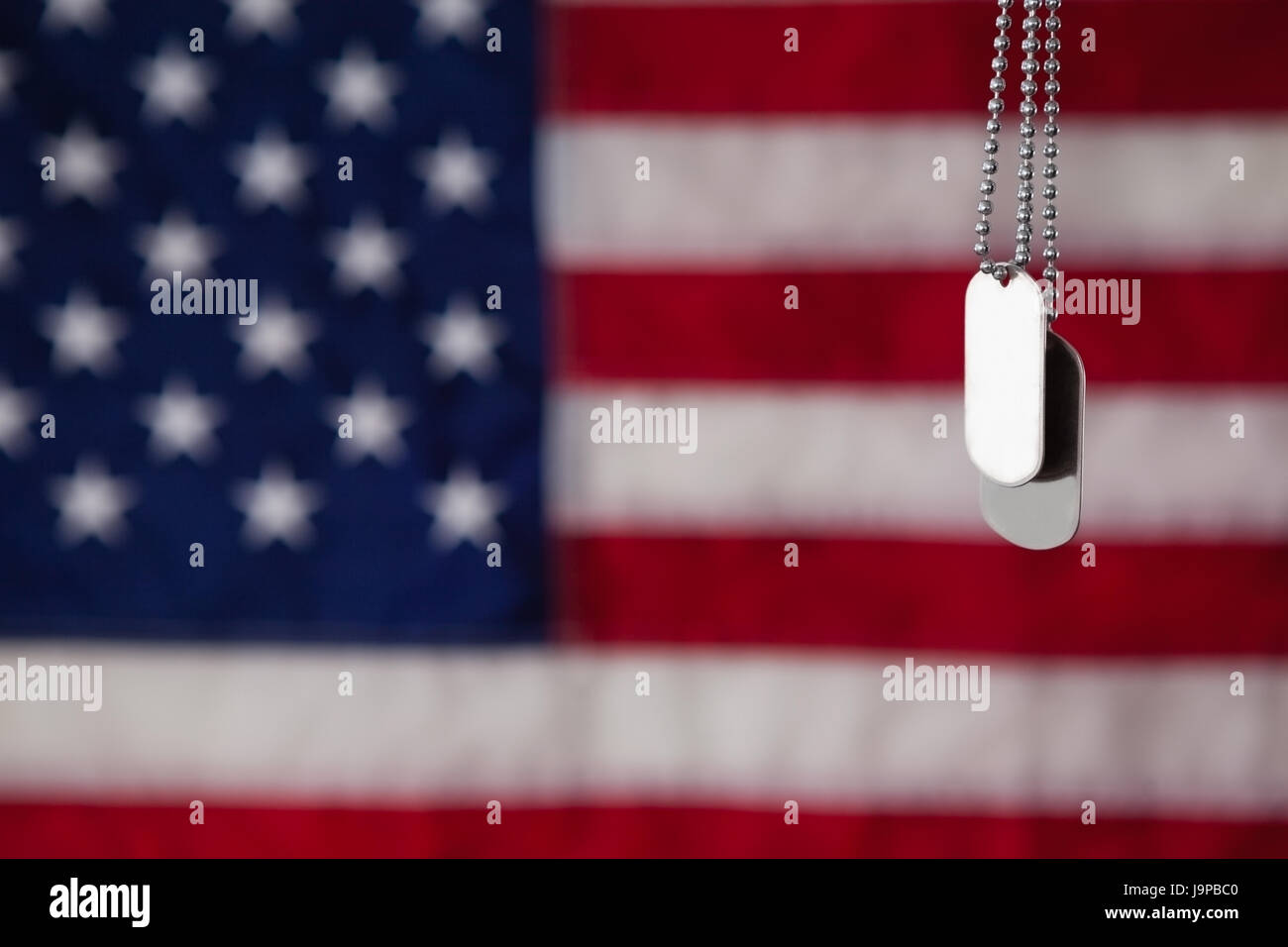 Close-up of dog tag hanging against American flag background Stock ...