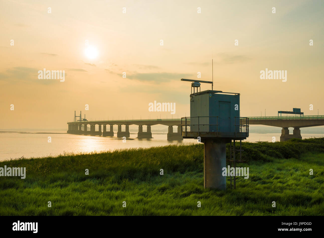 A shore-based radar tower at Severn Beach on the shore of the Severn Estuary with the Prince of Wales Bridge beyond, Gloucestershire, England. Stock Photo