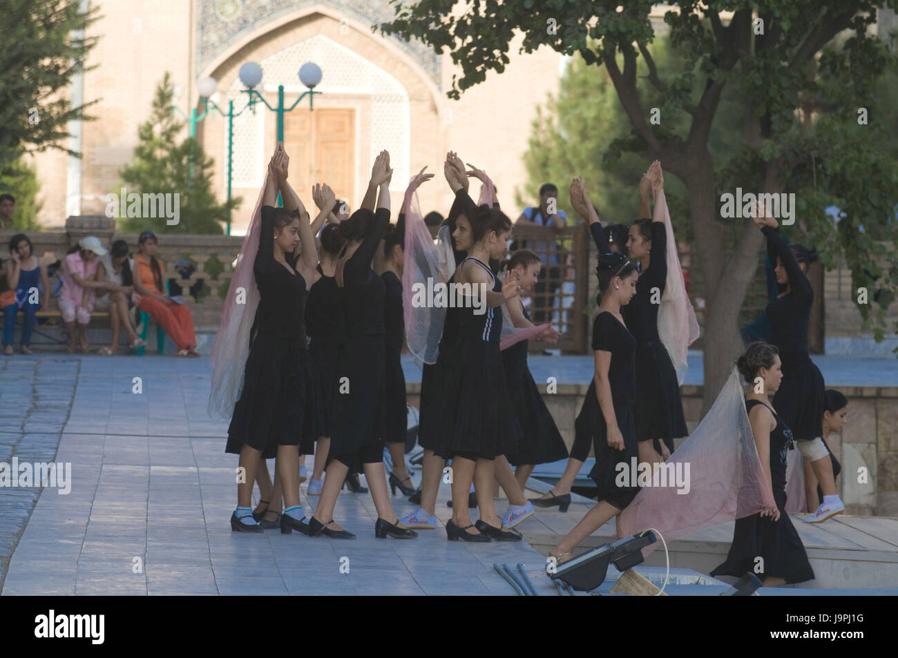 Young women prepare a dance in the Registan,Samarkand,Uzbekistan, Stock Photo