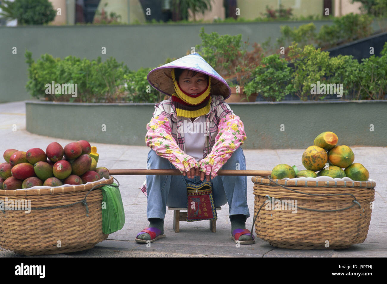 China,Hainan Iceland,Sanya,Dadonghai Beach,fruit merchant,sit,no model release,Asia,Eastern Asia,destination,person,tourism,sales,shop assistant,care,headgear,whole body,product,baskets,costs baskets,mangos,papayas,fruits,fruit,street sales,clothes,typically, Stock Photo