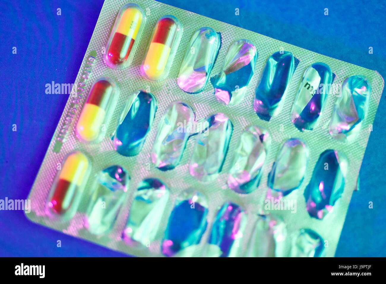 Still life dramatic lighting of Amoxicillin tablets in and out of packets, used for bacterial infections Stock Photo