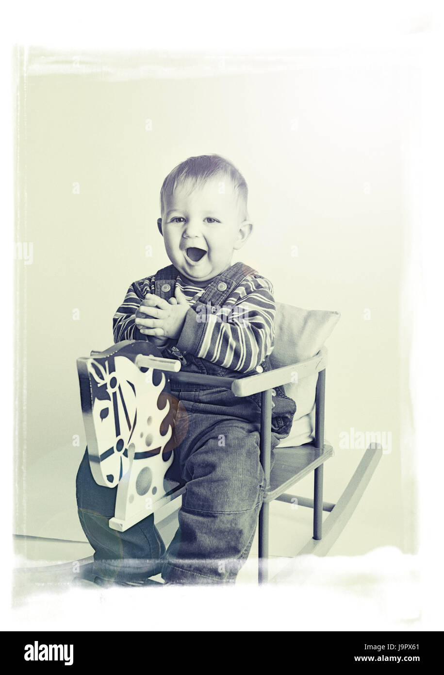 Rocking horse,infant,fun,s/w,child,younger generation,girl,grow up,play education,experience,fun,joy,vividly,sing,clap,toys,motion, Stock Photo