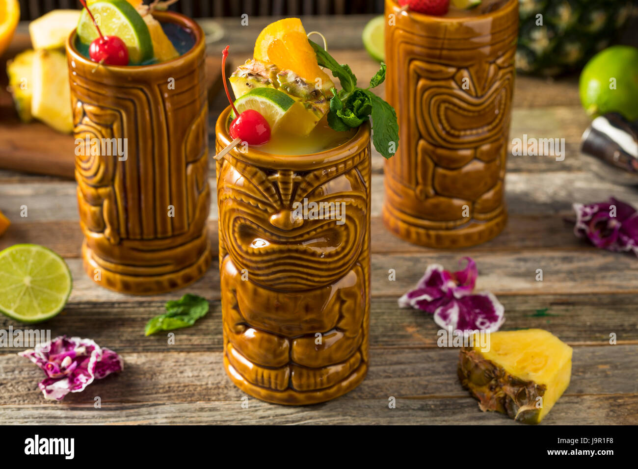 Refreshing Cold Tiki Drink Cocktails with Pineapple Cherry Orange