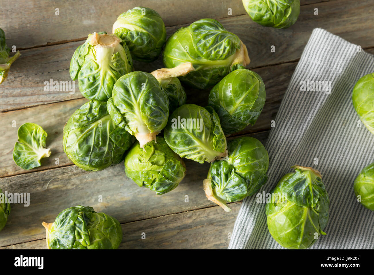 Raw Organic Green Brussel Sprouts Ready to Cook With Stock Photo