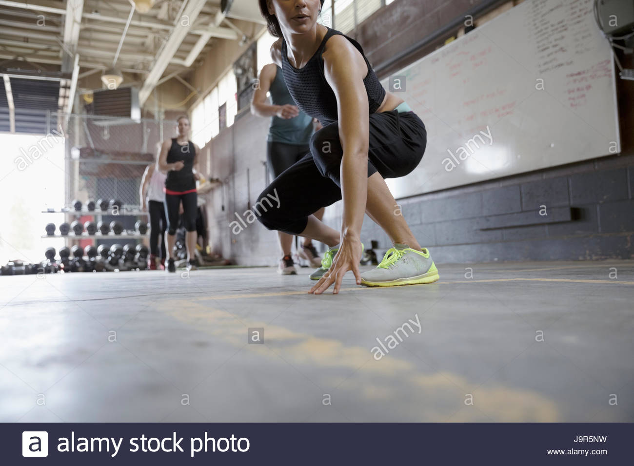 Strong women running lines in crossfit exercise class in gym Stock