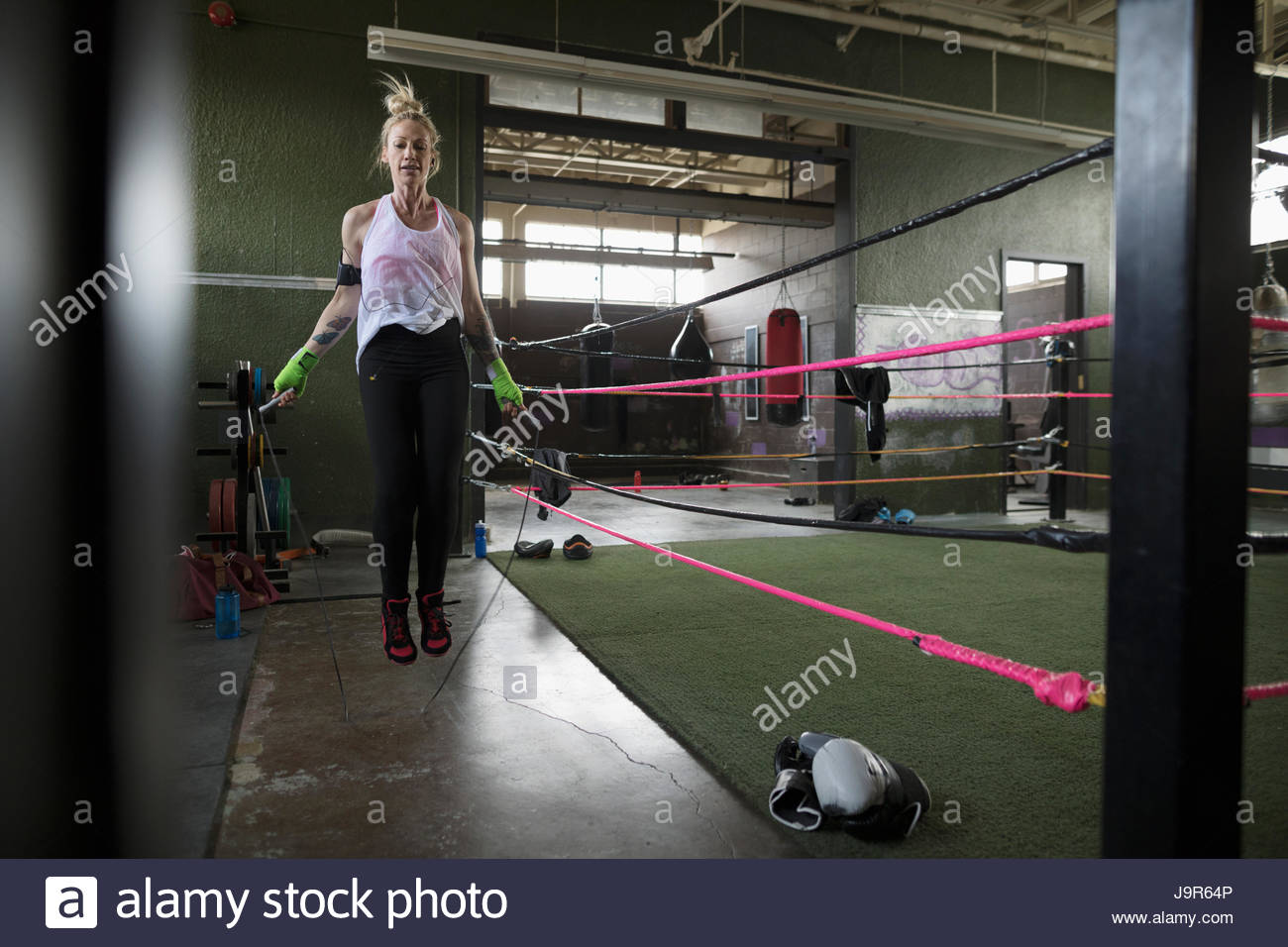 Female boxer jumping rope next to boxing ring Stock Photo Alamy