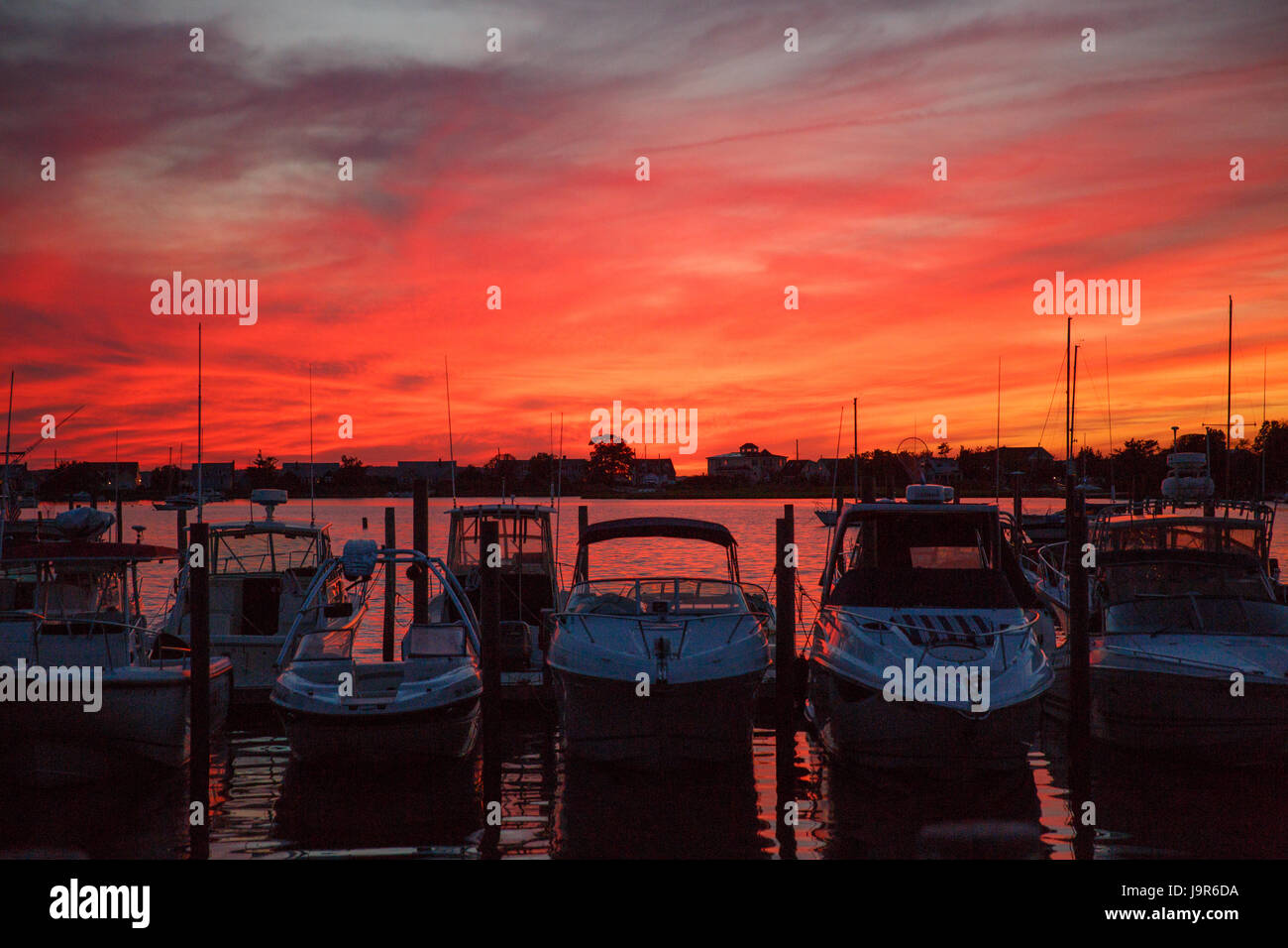 sunset view at sag harbor in the hamptons with powerboats at the docks, Stock Photo