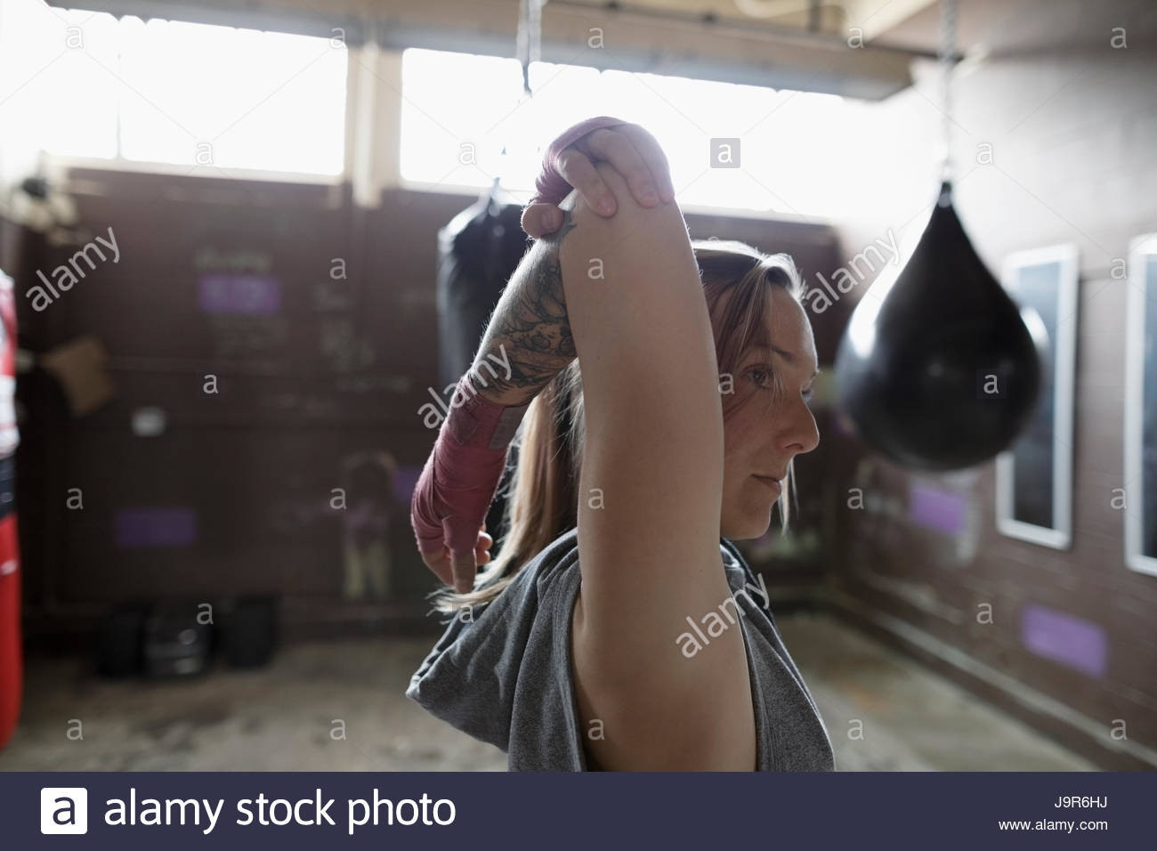 Female boxer stretching arm in gym Stock Photo