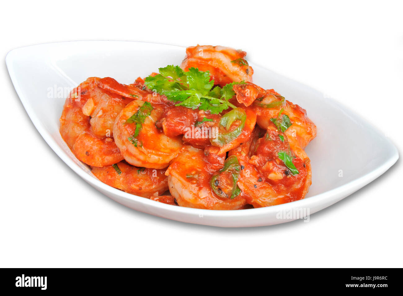 Clean plated white dish of prawns, with a red tomato sauce covering Stock Photo