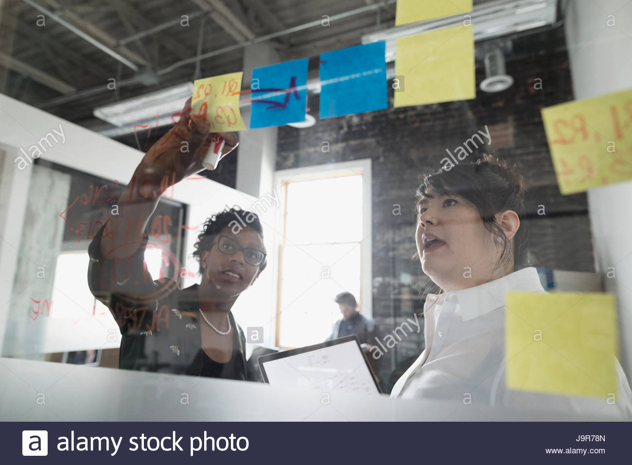 Creative businesswomen meeting, brainstorming with adhesive notes at