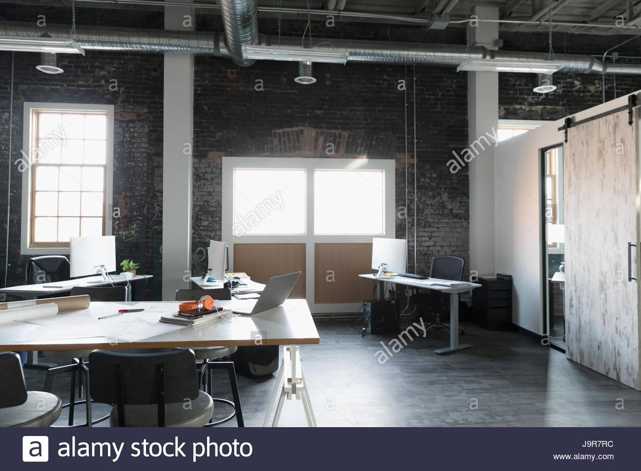 Desks in empty loft creative open plan office Stock Photo Alamy