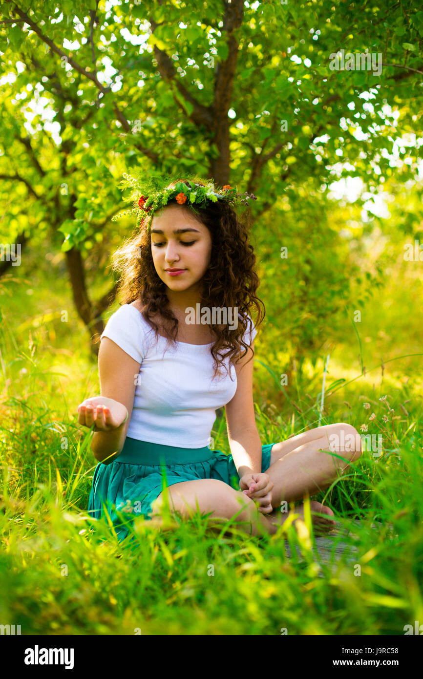 Young girl in green garden in the morning Stock Photo