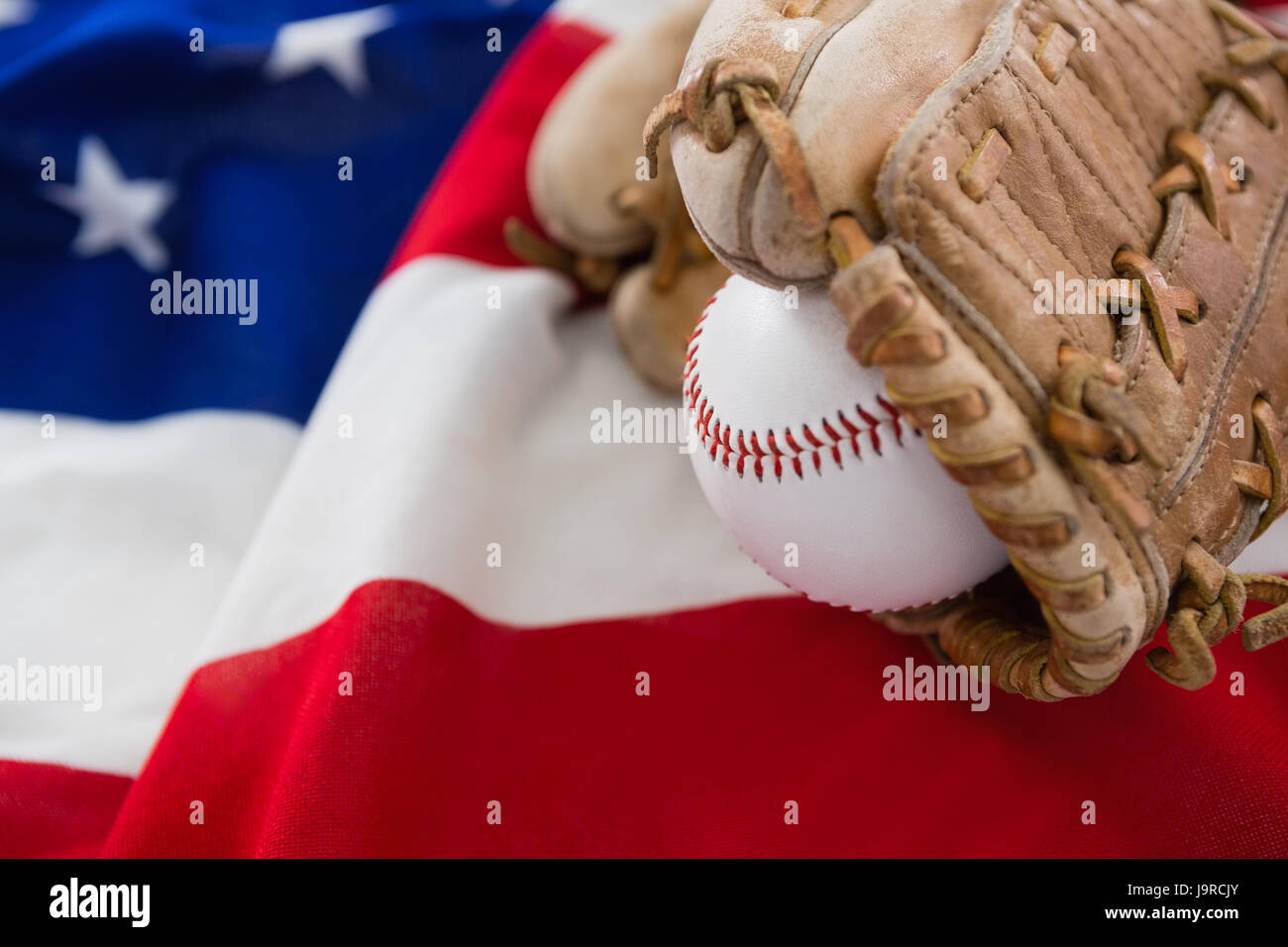 Close-up of baseball and gloves on an American flag Stock Photo - Alamy
