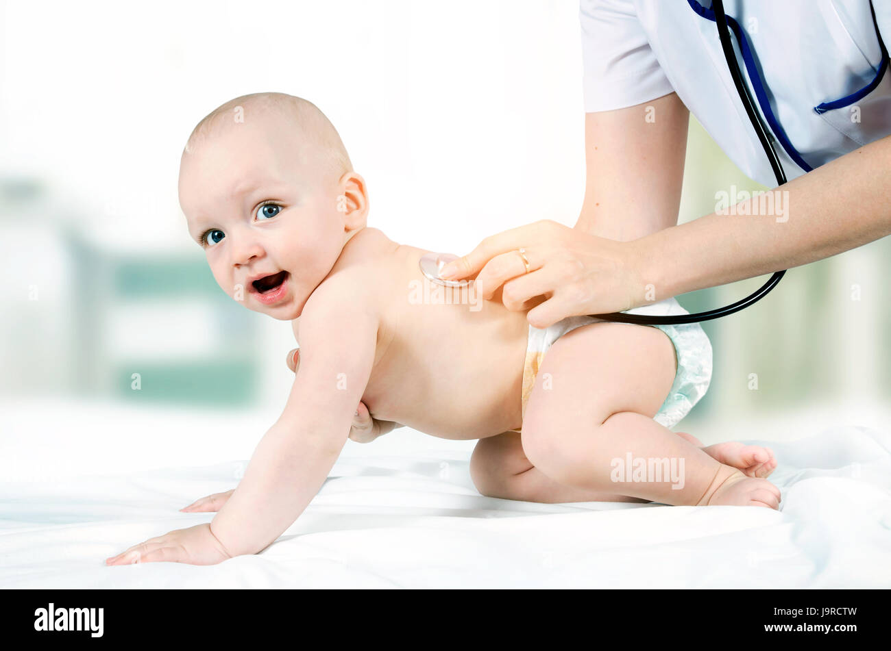 Little child treated by a doctor Stock Photo