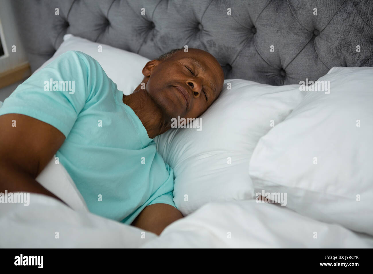Carefree senior man sleeping on bed at home Stock Photo - Alamy