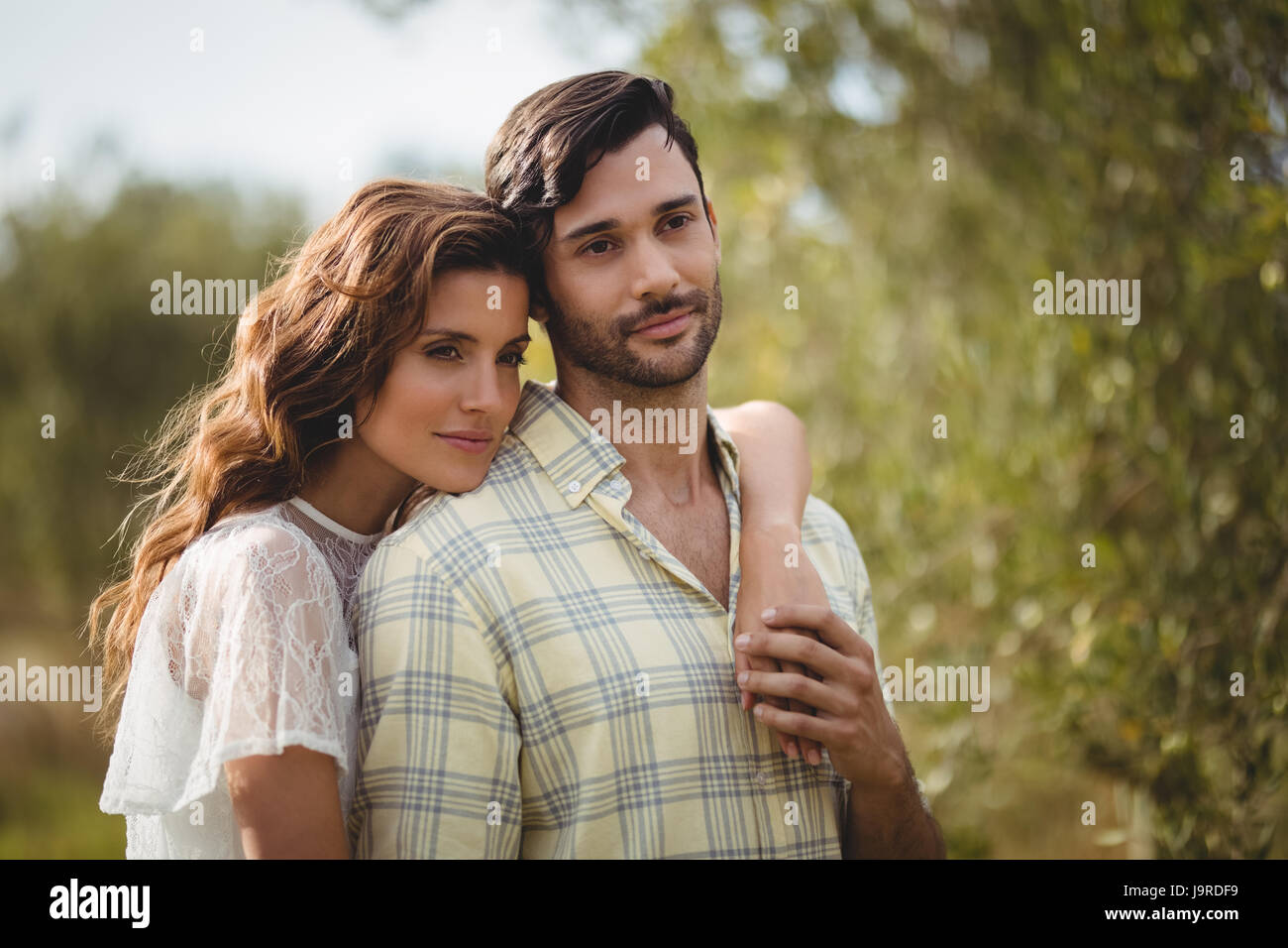 Loving young couple standing together at farm on sunny day Stock Photo ...