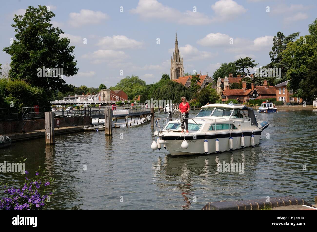View of the River Thames  from Marlow Lock, Marlow, Buckinghamshire, towards the parish church and suspension bridge. Stock Photo