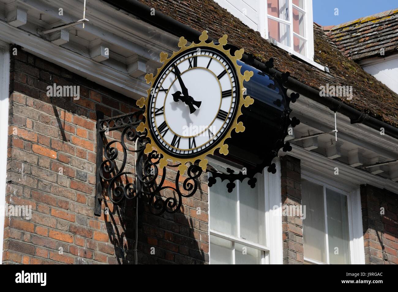 Clock hanging on bracket over the High St, Royston, Hertfordshire Stock