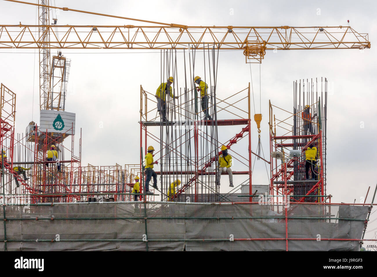 Workers fixing concrete reinforcement rods on a construction site in Bangkok, Thailand Stock Photo