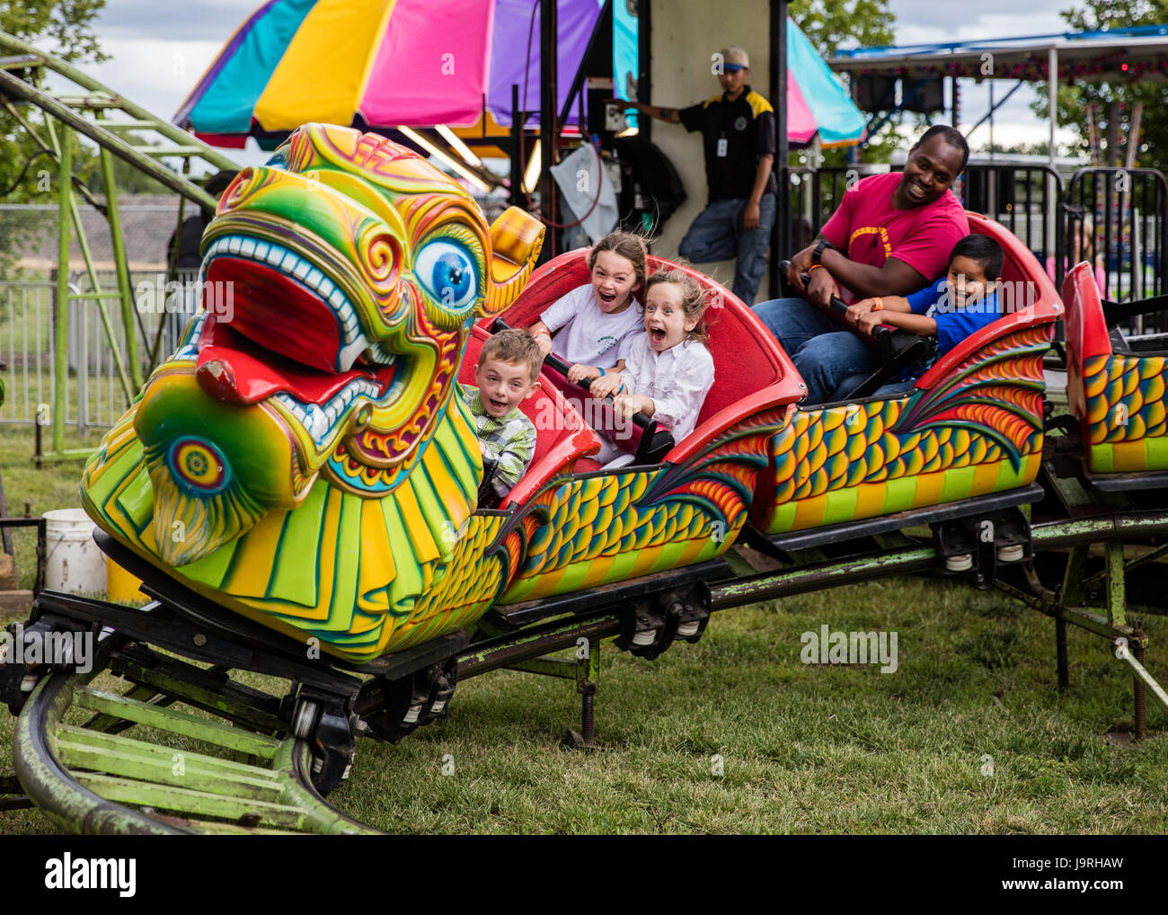 Riding a Chinese dragon at the county fair Stock Photo - Alamy