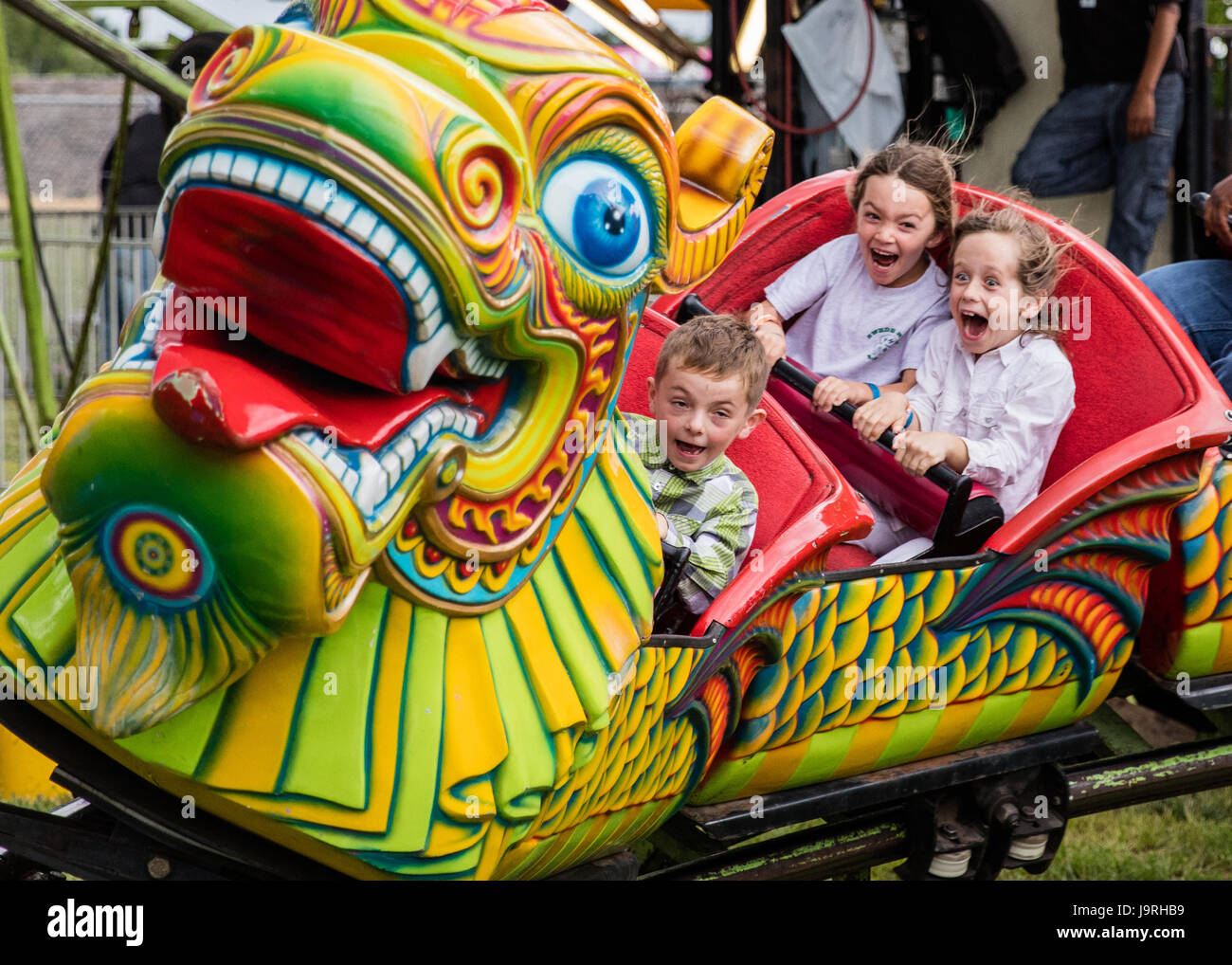 Riding a Chinese dragon at the county fair Stock Photo - Alamy