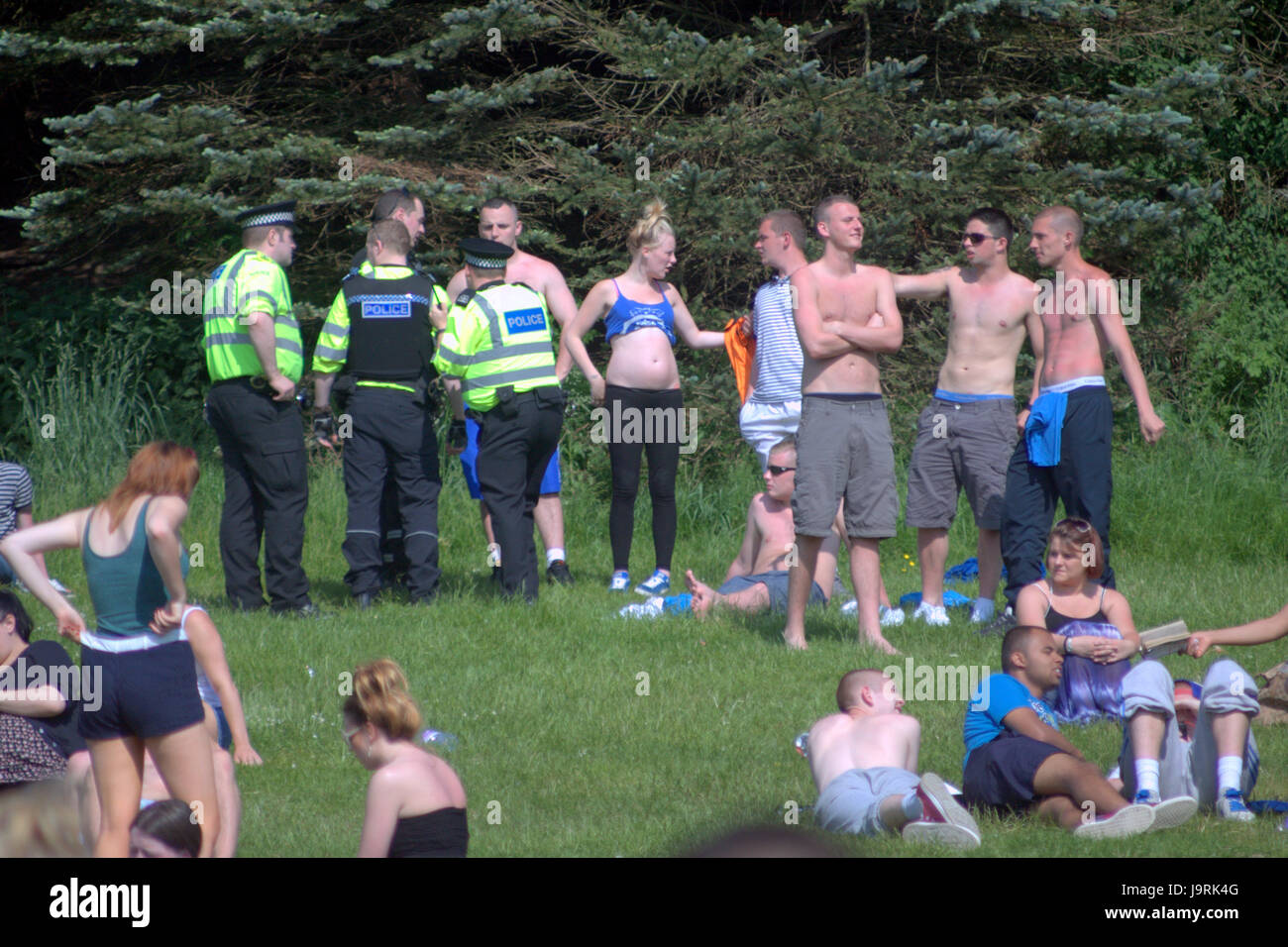west end Kelvingrove park festival celebrations neds teenagers in trouble with the police during sunny weather or 'taps aff' tops off weather Stock Photo