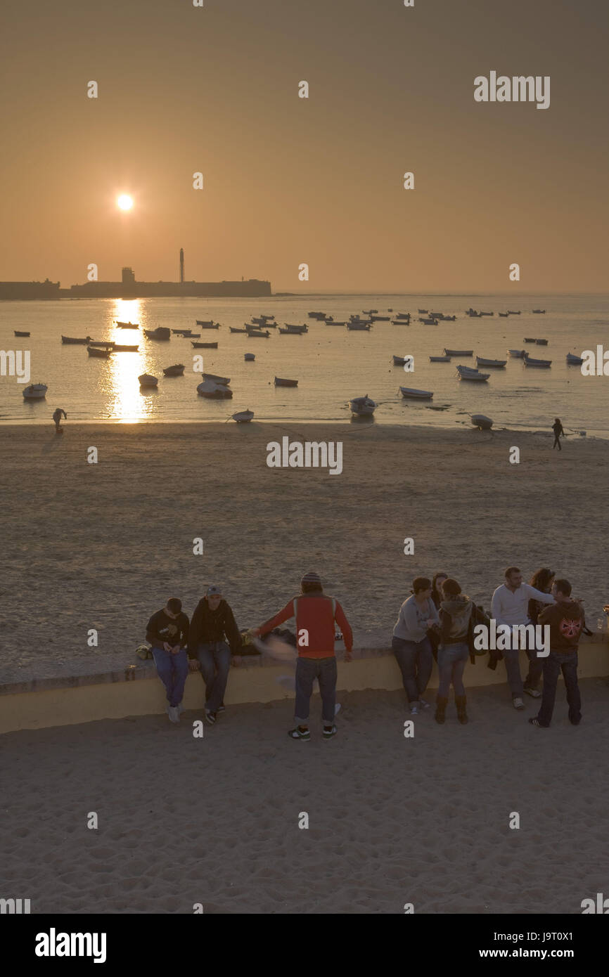 Spain,Andalusia,Cadiz,Playa de la Caleta,beach,fishing boats,locals,Spaniards,sundown,evening tuning, Stock Photo