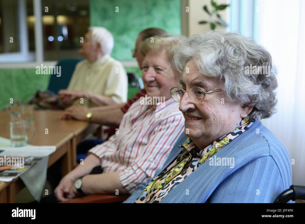 Old people's home,seniors,smile,leisure time,sit,table,newspaper,detail,at the side,portrait,person,read,old people's home,social contacts,leisure time activity,old person,old,home inhabitant,old age,company,entertainment,community,women,man,inside,senior citizens, Stock Photo