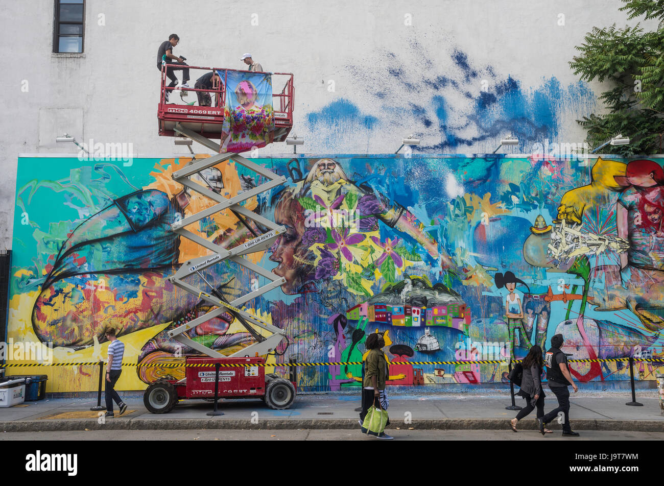 New York, NY 2 June 2016 - Korean American artist David Choe takes ta break from painting to speak with fans  in the lift, at the Houston Bowery Mural. © Stacy Walsh Rosenstock Stock Photo