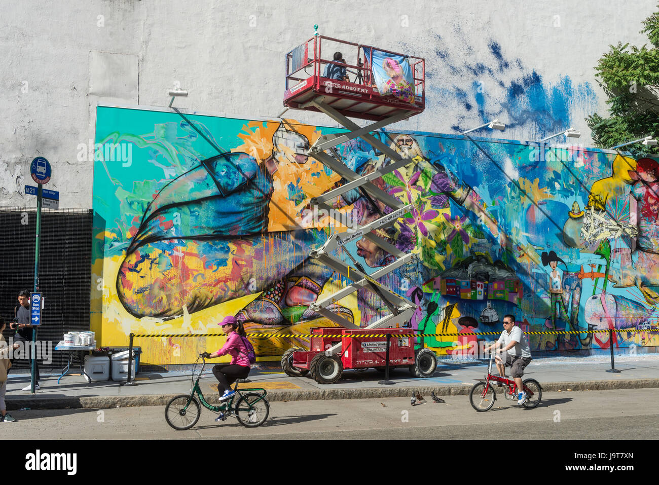 New York, NY 2 June 2016 - Korean American artist David Choe takes a break from painting to speak with fans  in the lift, at the Houston Bowery Mural. © Stacy Walsh Rosenstock Stock Photo