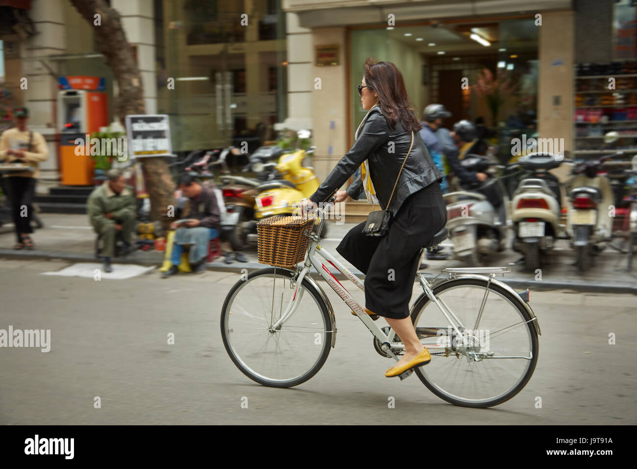 Stylish woman on bicycle, Old Quarter, Hanoi, Vietnam Stock Photo