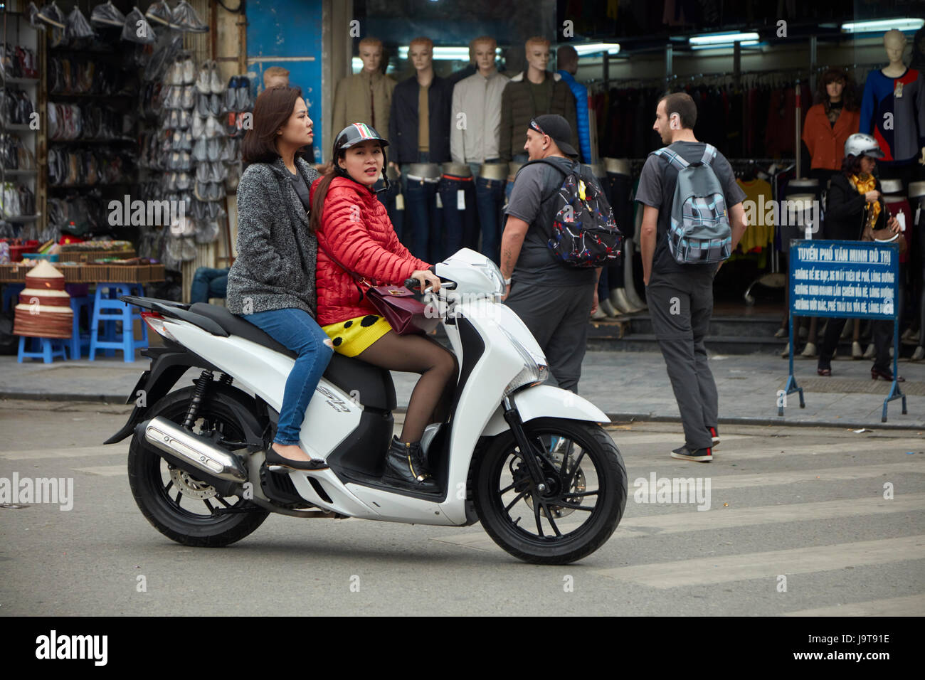 Stylish women on scooter, Old Quarter, Hanoi, Vietnam Stock Photo