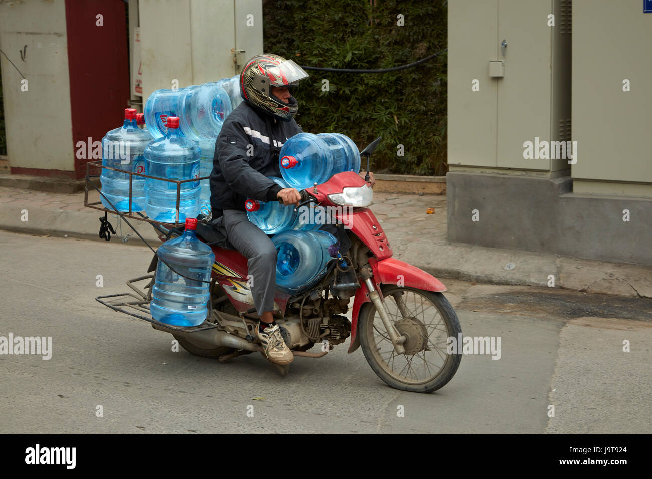Motorbike overloaded with water bottles Old Quarter Hanoi