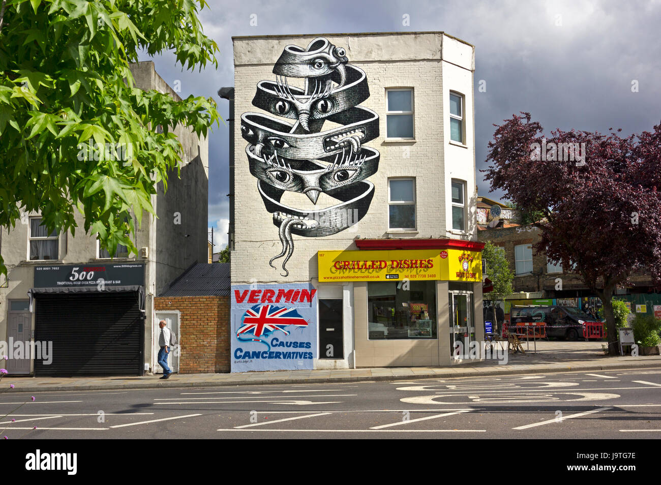 'VERMIN Causes Cancervatives' New political mural by street artist Artful Dodger on a wall in Herne Hill, SE London. Above it a fantastical mural inspired by M. C. Escher by London-based muralist and street artist, Phlegm. Stock Photo