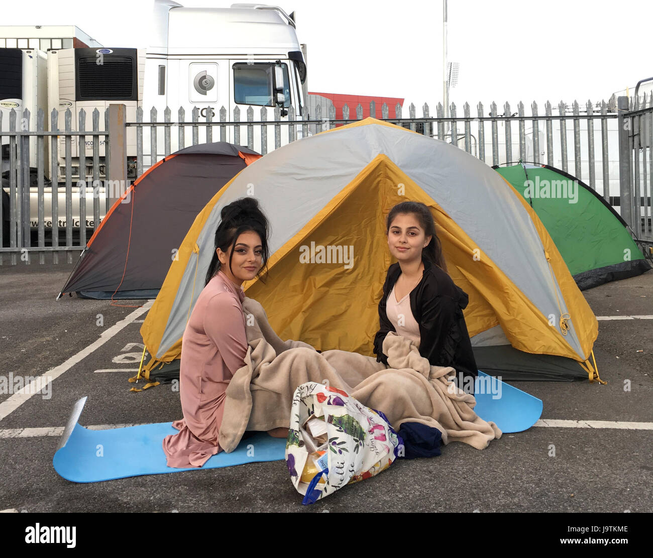Manchester, UK. 3rd June, 2017. sisters l-r Yasmin Ishaq (aged 19) and Nadiq Ishaq aged 18 are first in the queue for tomorrows One love concert at the Emirates Old Trafford stadium. Both sisters survived the bombing at the Ariana Grande concert on 22nd May 2017 in Manchester. They escaped via the fire escape. They face a long night as they arrived without a tent( tents in background belong to other people in queue. Credit: GARY ROBERTS/Alamy Live News Stock Photo
