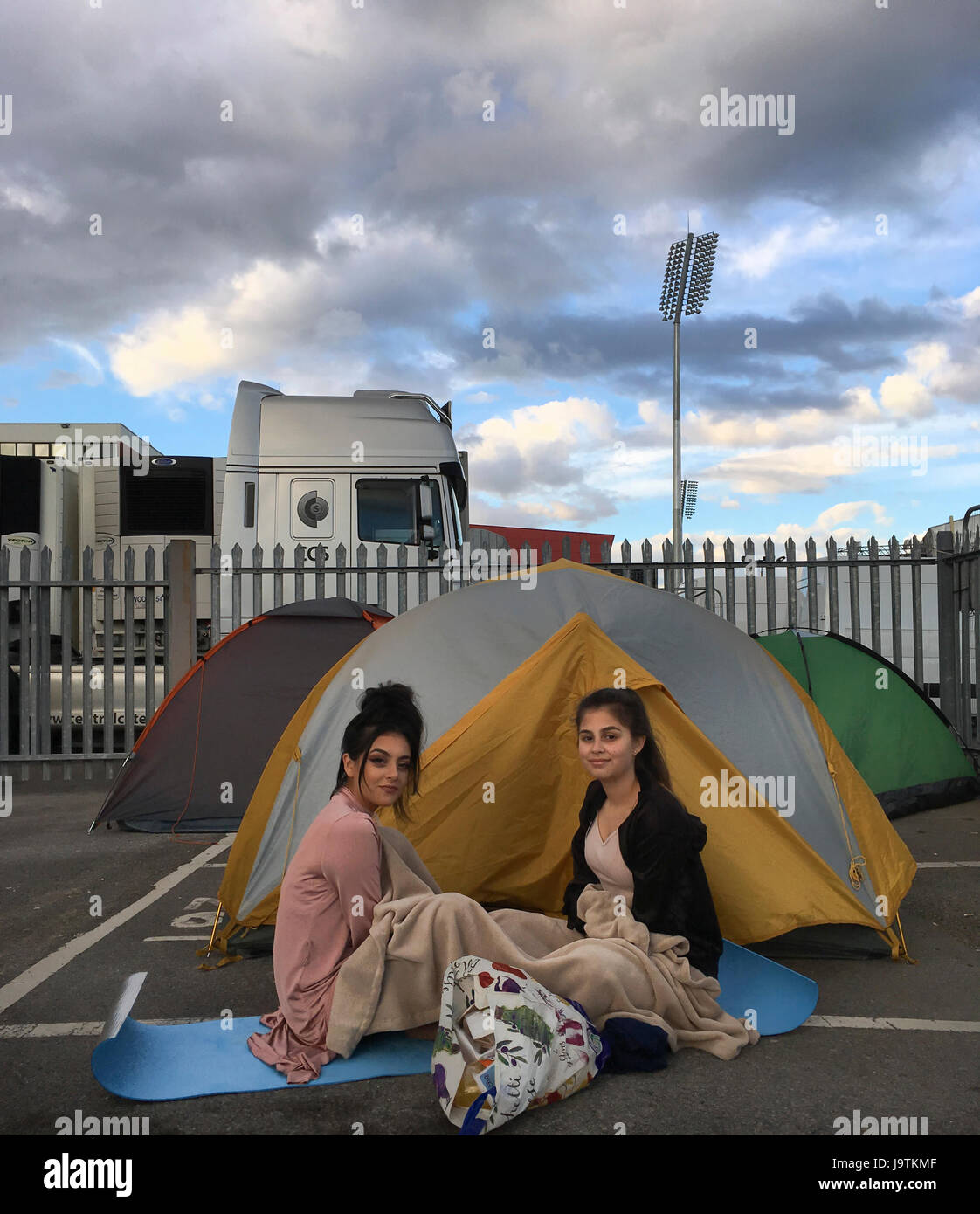 Manchester, UK. 3rd June, 2017. sisters l-r Yasmin Ishaq (aged 19) and Nadiq Ishaq aged 18 are first in the queue for tomorrows One love concert at the Emirates Old Trafford stadium. Both sisters survived the bombing at the Ariana Grande concert on 22nd May 2017 in Manchester. They escaped via the fire escape. They face a long night as they arrived without a tent( tents in background belong to other people in queue. Credit: GARY ROBERTS/Alamy Live News Stock Photo