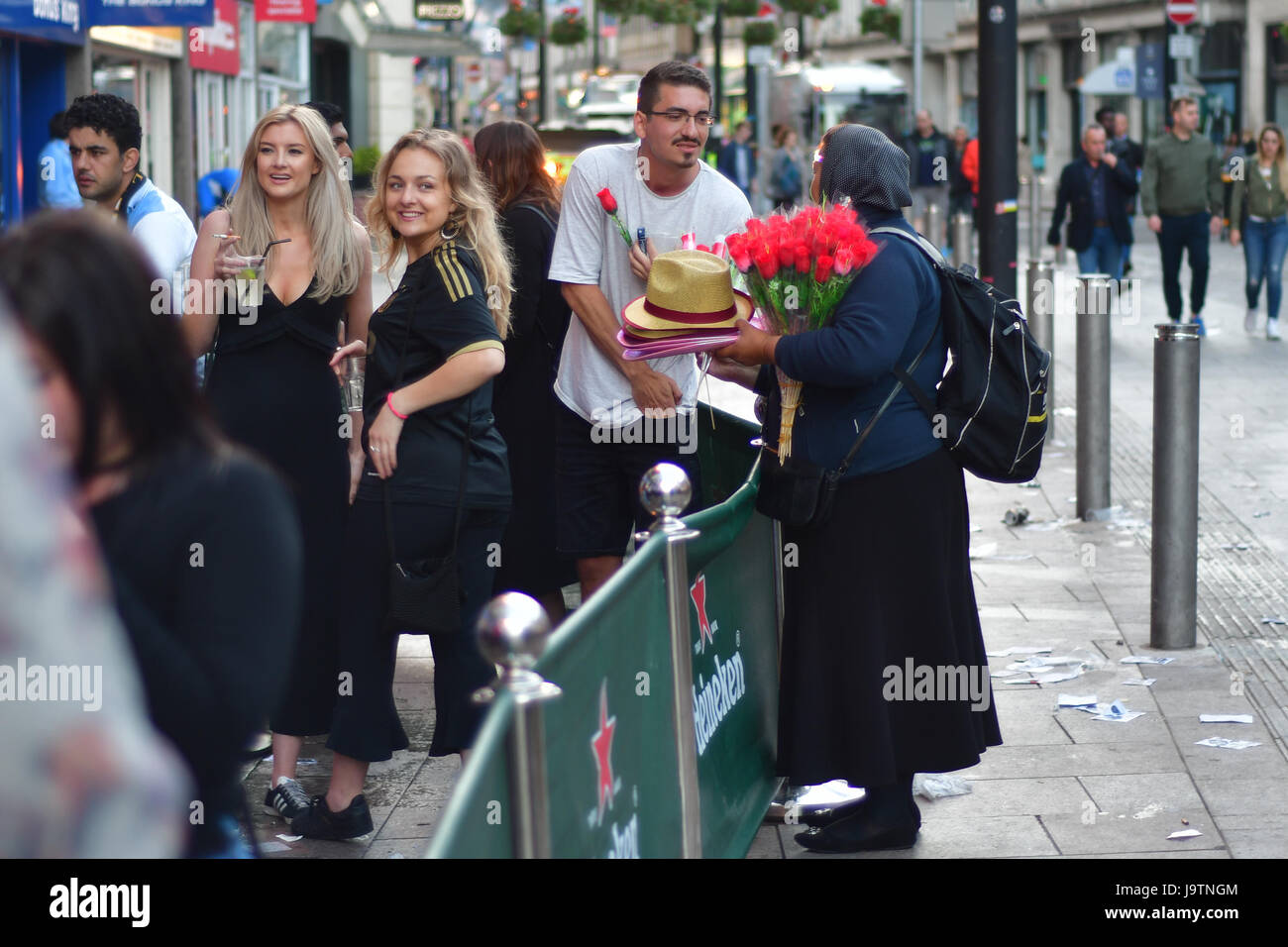 CARDIFF, UK. 3rd June, 2017. Flower seller and partygoers during Champions League Final. British security services on high alert as hundreds of thousands of fans enjoy football in the capital of Wales Credit: Ian Redding/Alamy Live News Stock Photo