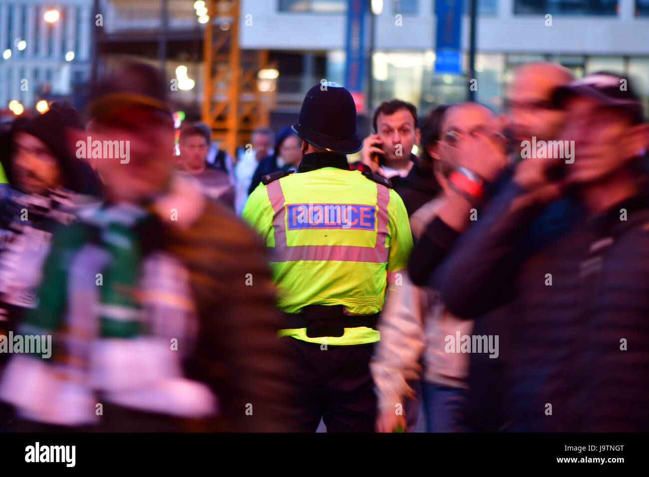 CARDIFF, UK. 3rd June, 2017. Policeman standing amongst fans during Champions League Final. British security services on high alert as hundreds of thousands of fans enjoy football in the capital of Wales Credit: Ian Redding/Alamy Live News Stock Photo