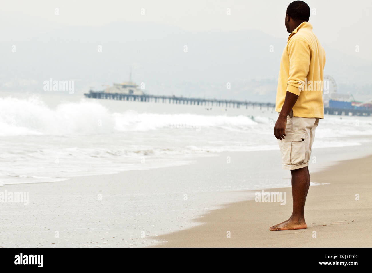 African American man walking on the beach Stock Photo - Alamy