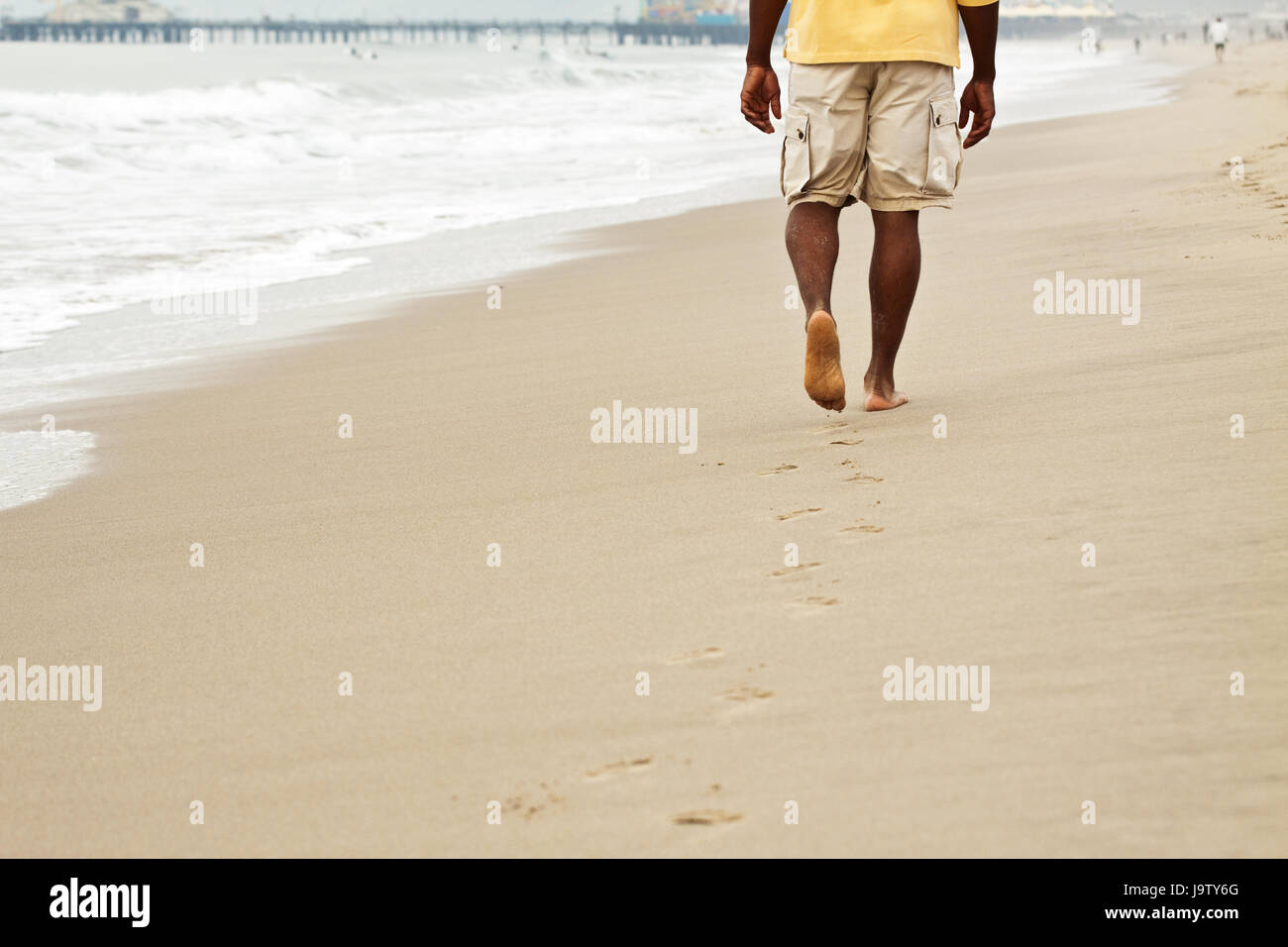 African American man walking on the beach Stock Photo - Alamy
