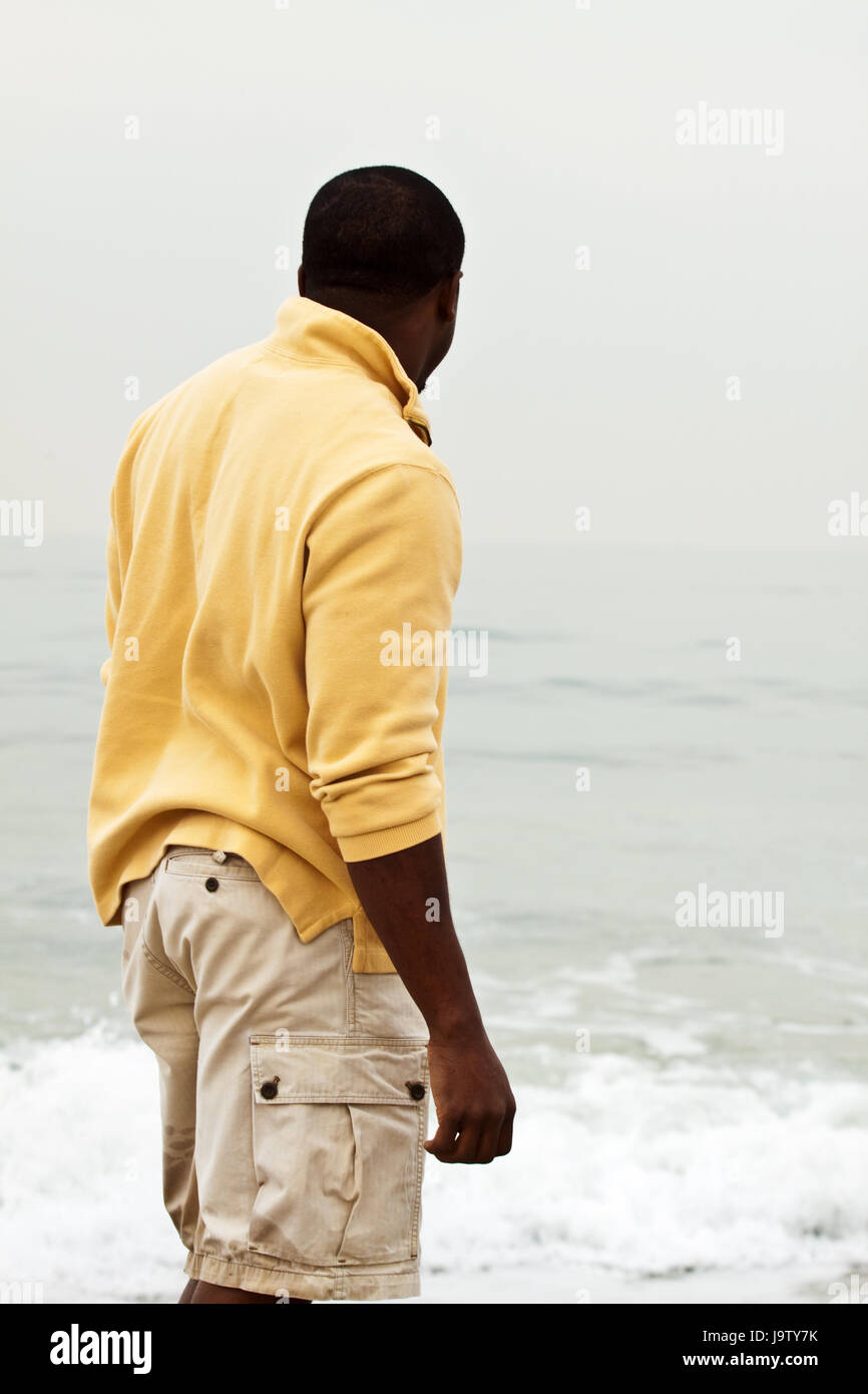 African American man walking on the beach Stock Photo - Alamy