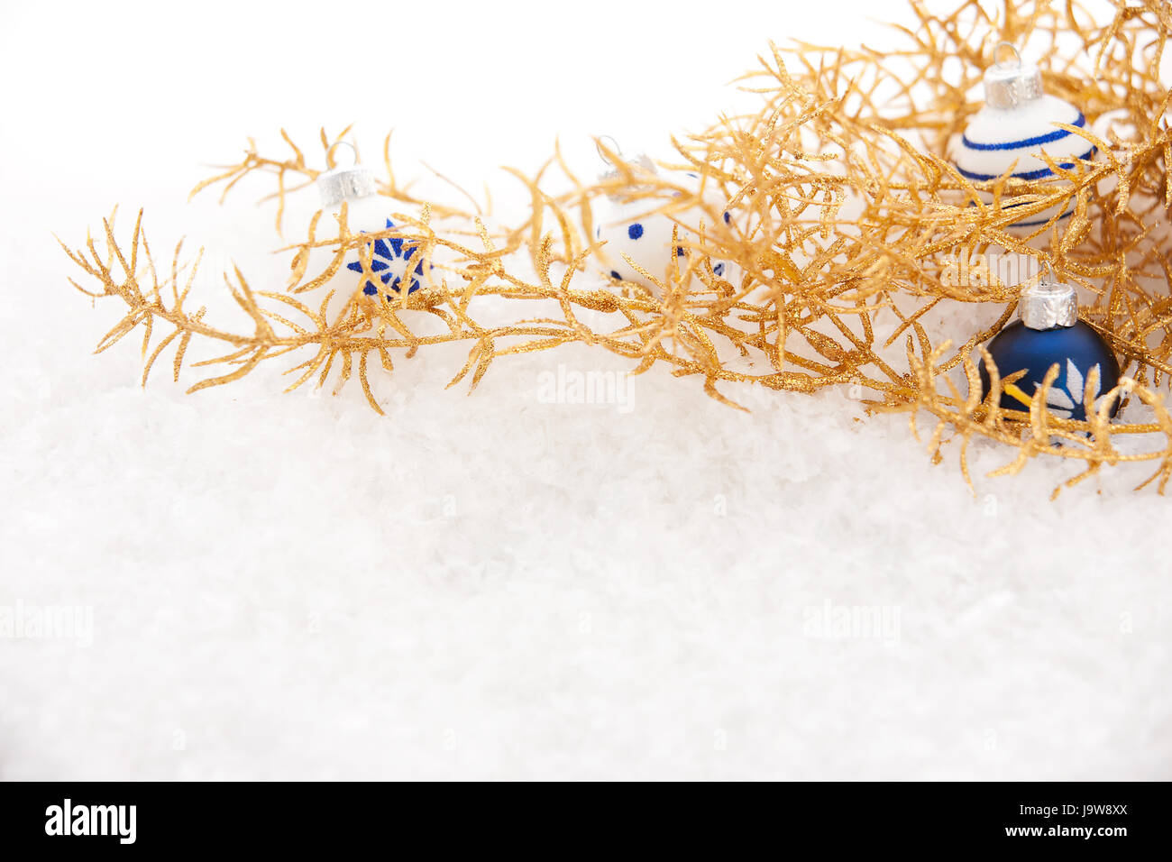 golden christmas with snow and christmas balls Stock Photo