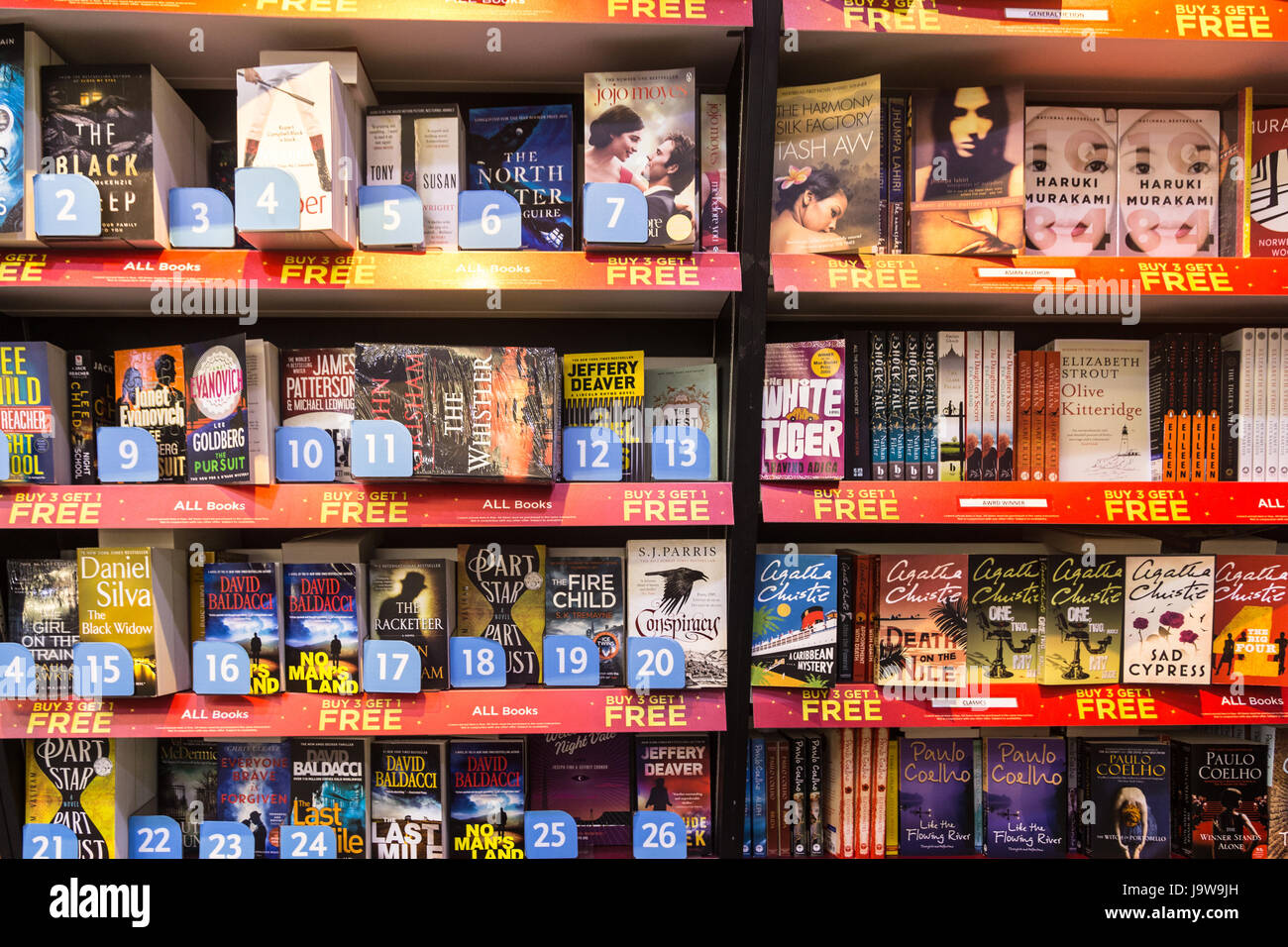 KUALA LUMPUR, MALAYSIA - MAY 19, 2017: Best seller novel books, including from Murakami, are displayed in a bookstore in an airport. Stock Photo