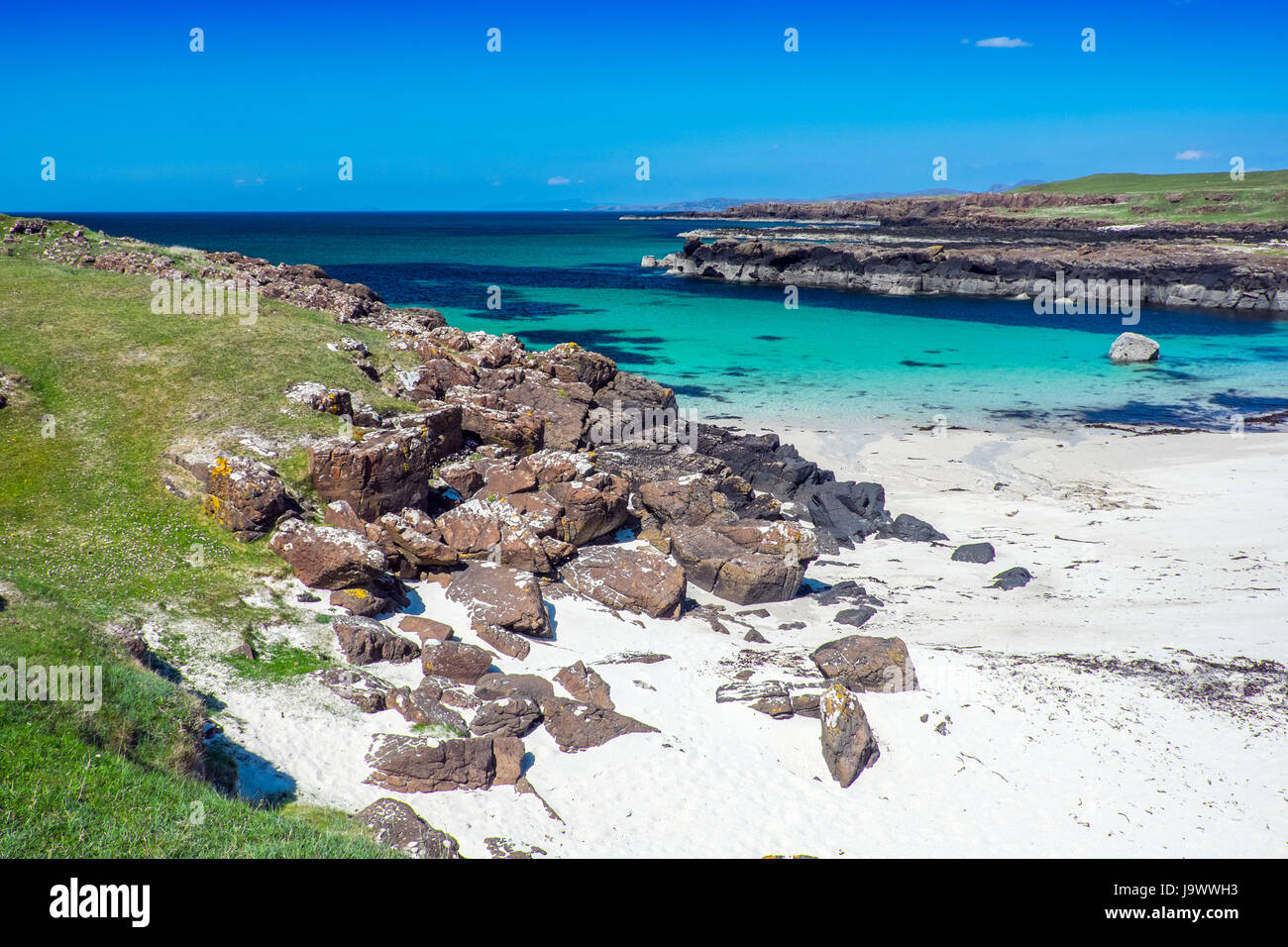 Crystal clear waters and white sand at Langamull beach on the north coast of Mull in the Scottish Hebrides Stock Photo