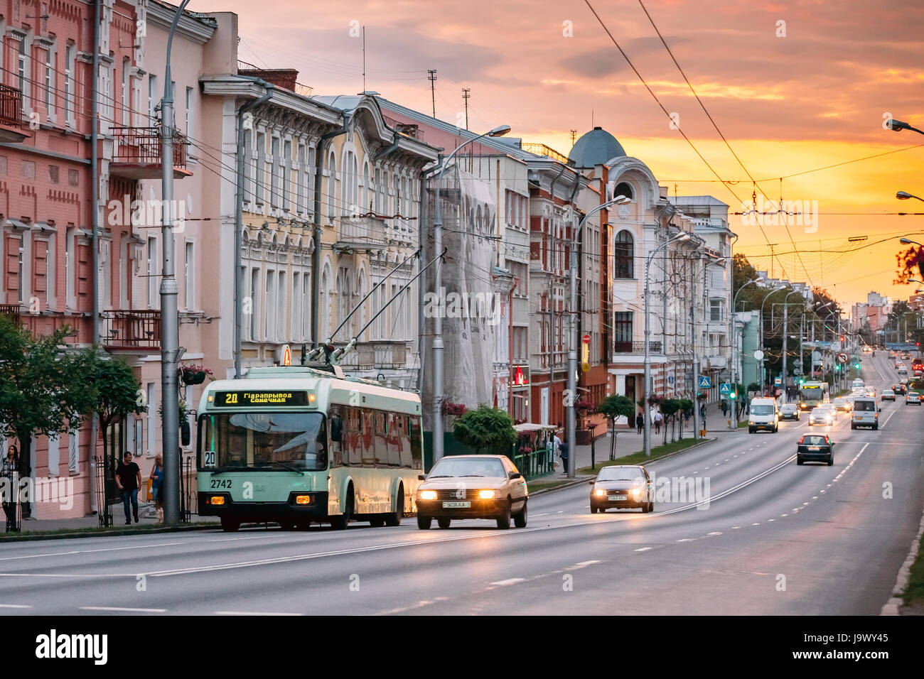 Gomel, Belarus - July 19, 2016: Evening Traffic And Public Trolleybus On Sovetskaya Street Dramatic Sky With Warm Colors At Sunset. Stock Photo